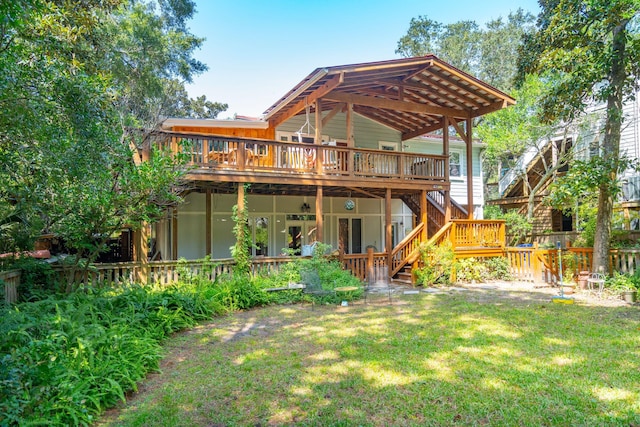 rear view of property with a yard and a deck