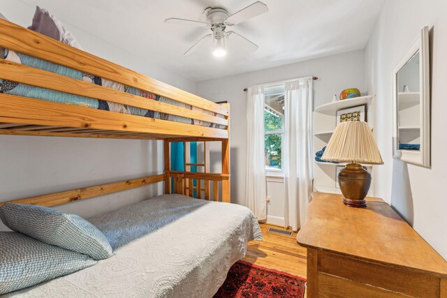 bedroom with light hardwood / wood-style flooring and ceiling fan