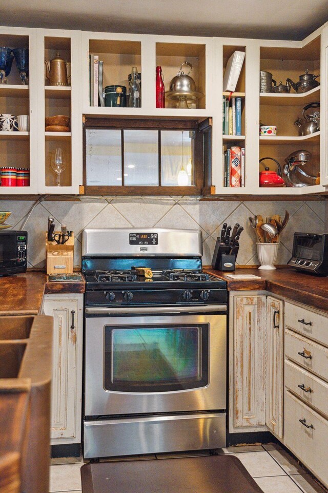 kitchen featuring stainless steel range with gas cooktop and light tile patterned flooring