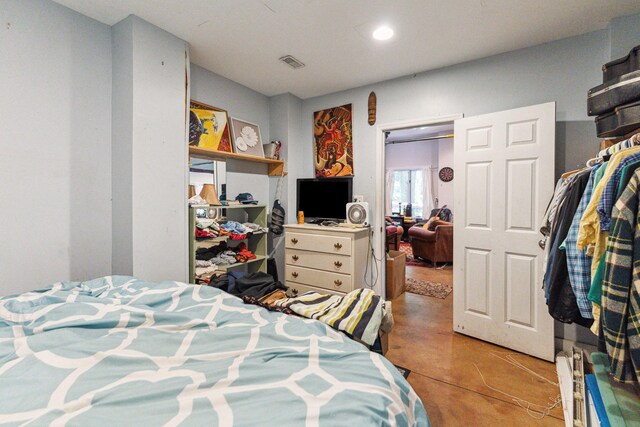 bedroom featuring a closet and concrete floors