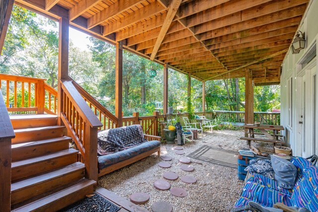 unfurnished sunroom featuring vaulted ceiling