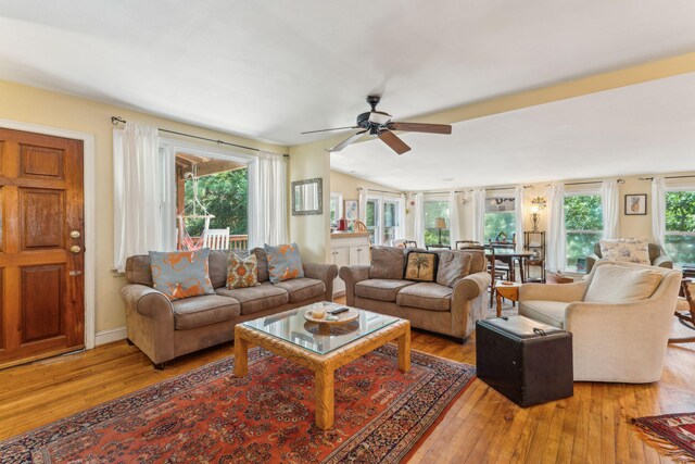 living room featuring light wood-type flooring and ceiling fan