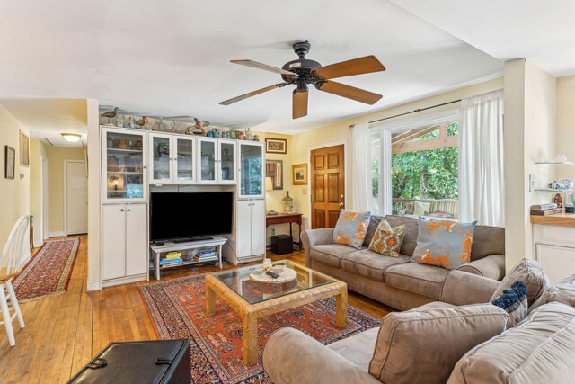 living room featuring ceiling fan and light wood-type flooring