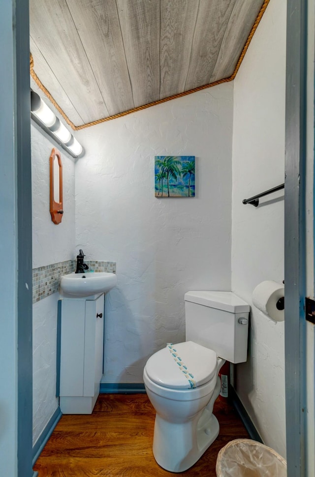 bathroom with vanity, wood-type flooring, wooden ceiling, and toilet