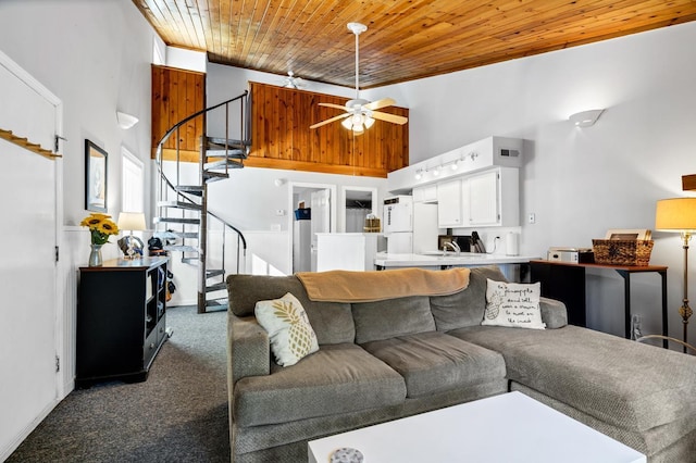 living room featuring carpet flooring, ceiling fan, wooden ceiling, and a high ceiling