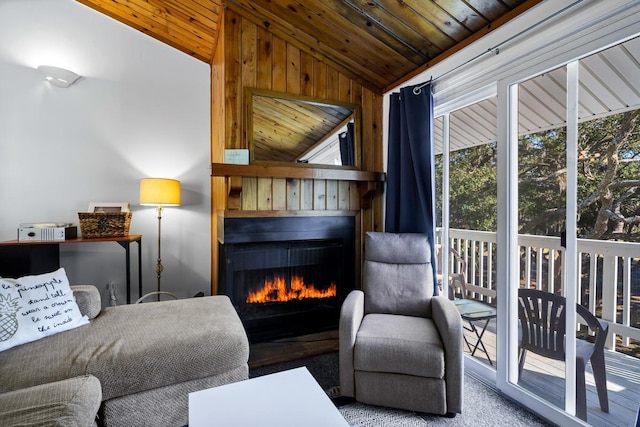 living area featuring carpet flooring, wood ceiling, and vaulted ceiling