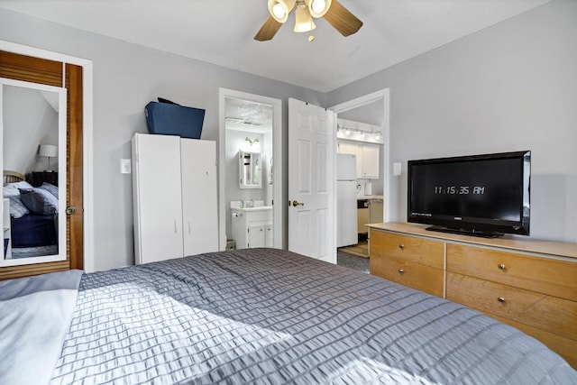 bedroom featuring ensuite bath, ceiling fan, and white refrigerator