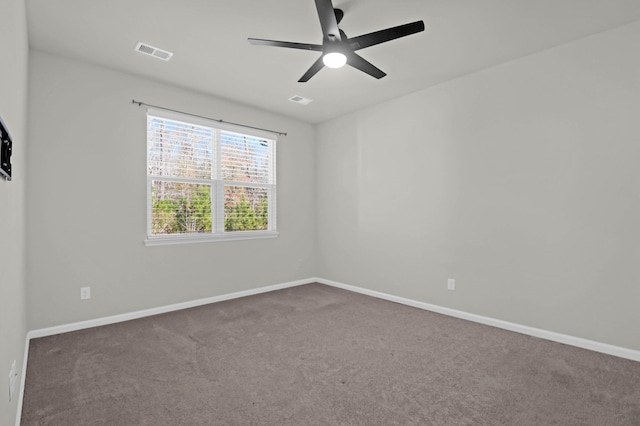 spare room with baseboards, visible vents, ceiling fan, and carpet flooring