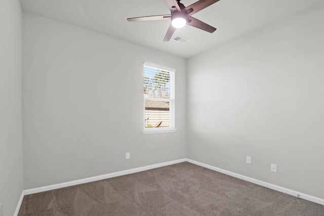 empty room featuring light carpet, a ceiling fan, visible vents, and baseboards