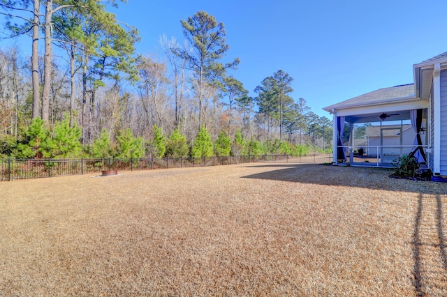 view of yard featuring a fenced backyard and a ceiling fan