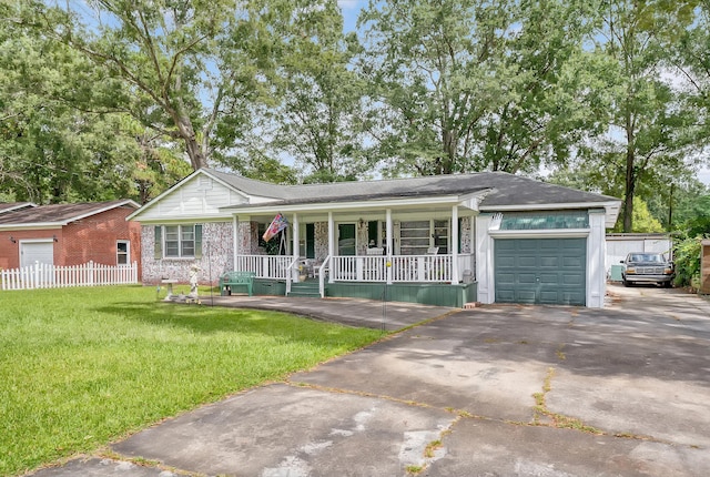 single story home featuring a garage, a front yard, and covered porch