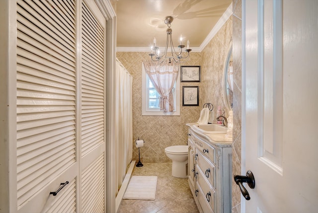 bathroom with tile patterned floors, toilet, a chandelier, vanity, and ornamental molding