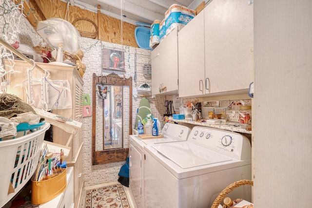 laundry area with tile patterned floors, cabinets, and washing machine and dryer