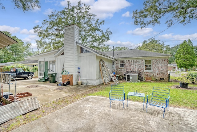 back of property with a yard and cooling unit