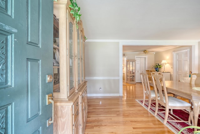 foyer featuring light wood-type flooring and crown molding