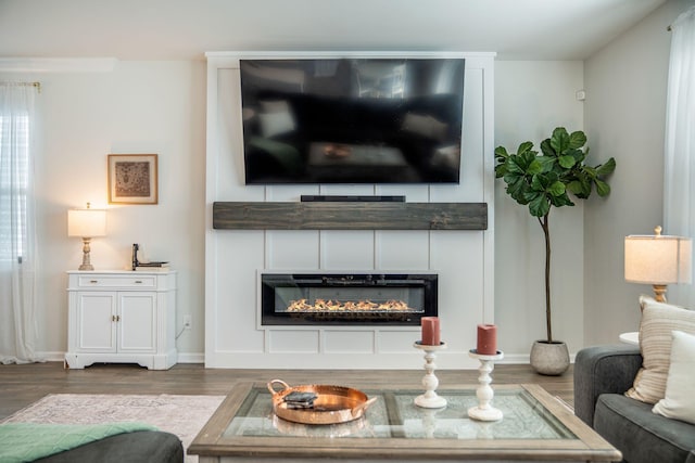 705 Squire Pope Rd, Summerville, SC 29486 - living area with wood finished floors, a glass covered fireplace, and baseboards