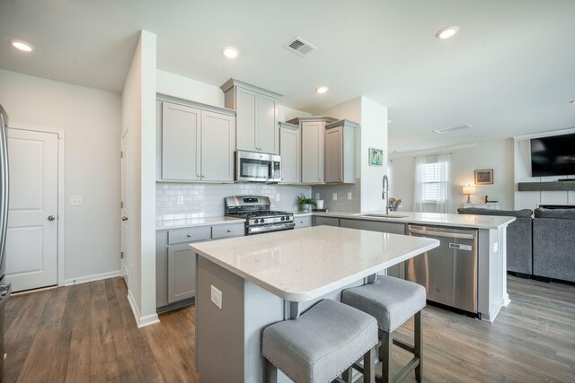 705 Squire Pope Rd, Summerville, SC 29486 - kitchen with appliances with stainless steel finishes, a sink, gray cabinets, open floor plan, and recessed lighting