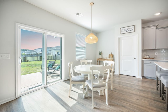 705 Squire Pope Rd, Summerville, SC 29486 - dining area featuring healthy amount of natural light, light wood-style flooring, and baseboards
