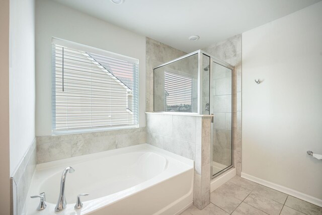 705 Squire Pope Rd, Summerville, SC 29486 - bathroom featuring a garden tub, a shower stall, tile patterned flooring, and baseboards