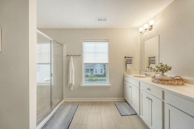 full bathroom with visible vents, baseboards, a shower stall, and vanity