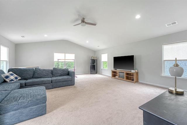 carpeted living room featuring a ceiling fan, baseboards, lofted ceiling, and visible vents