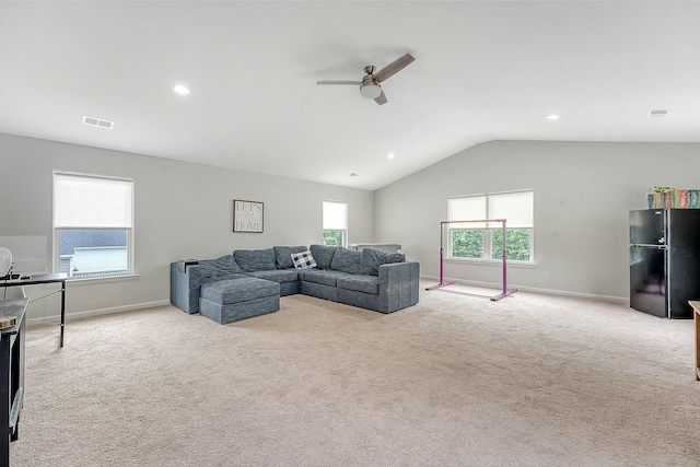 living area with ceiling fan, visible vents, carpet floors, lofted ceiling, and baseboards