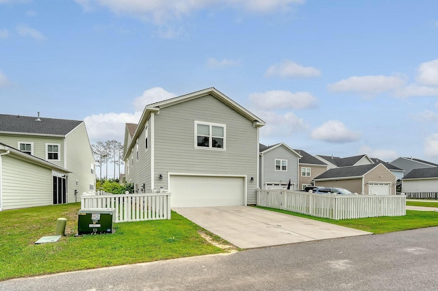 view of front of house featuring a residential view, driveway, a front lawn, a garage, and fence