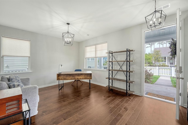 home office with a chandelier, wood finished floors, and a healthy amount of sunlight