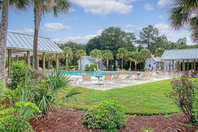 community pool featuring a yard and a patio