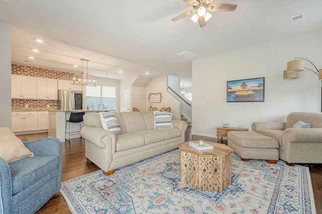 living room featuring recessed lighting, dark wood-style floors, stairs, visible vents, and ceiling fan