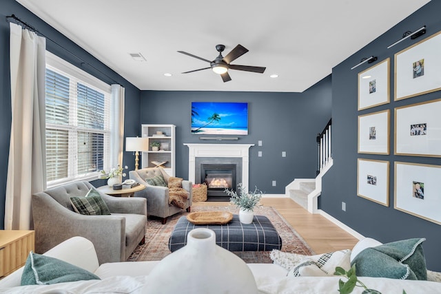 living room with ceiling fan and hardwood / wood-style flooring