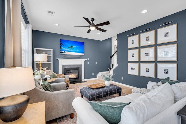 living room featuring ceiling fan and wood-type flooring