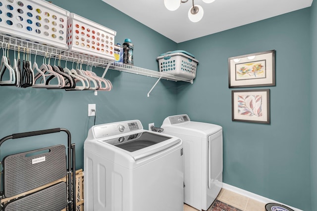 laundry area featuring washer and clothes dryer and light tile patterned floors