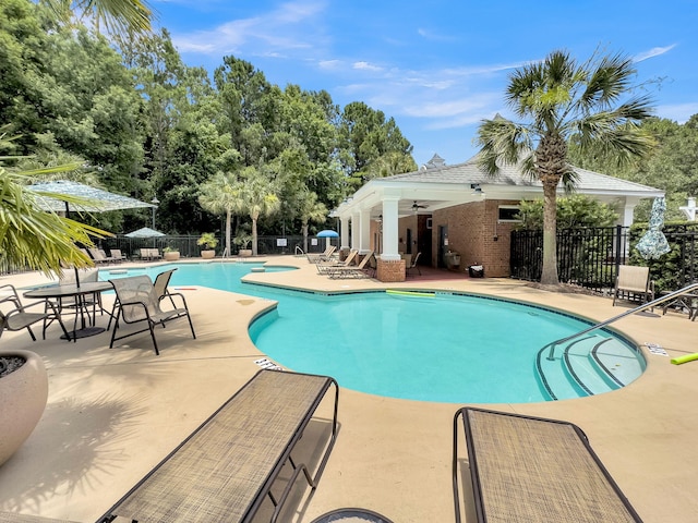 view of pool with ceiling fan and a patio