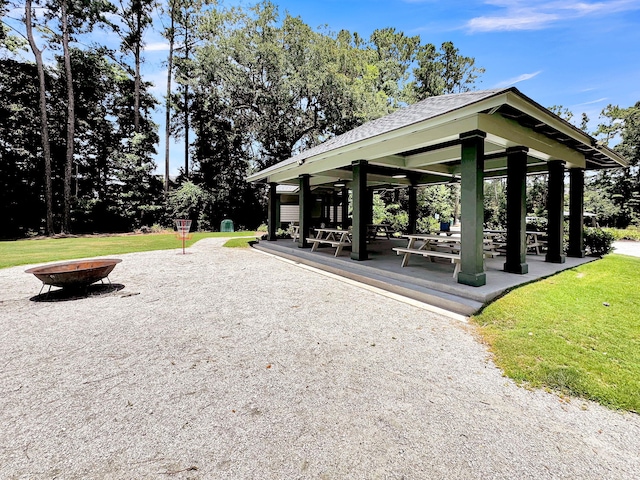 surrounding community with a lawn, a gazebo, and a fire pit