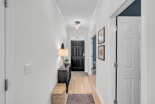 entryway featuring light wood-type flooring and crown molding