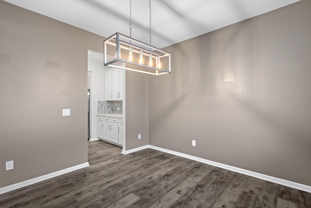 514 Purple Finch Rd, Summerville, SC 29486 - unfurnished dining area with dark wood-style flooring, baseboards, and a chandelier