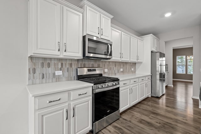 514 Purple Finch Rd, Summerville, SC 29486 - kitchen featuring stainless steel appliances, dark wood-style floors, white cabinets, decorative backsplash, and light countertops