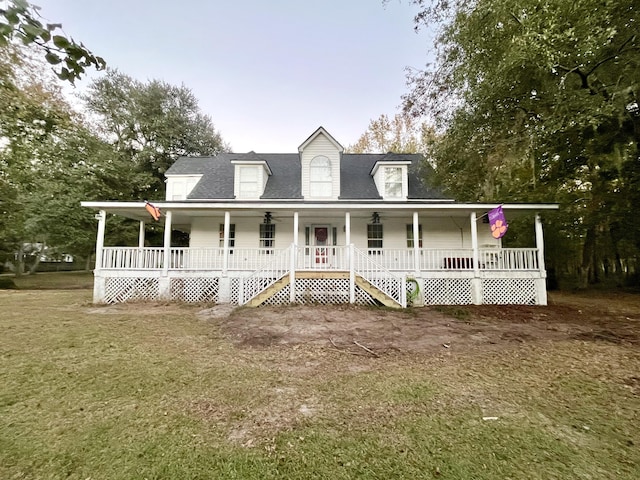 farmhouse inspired home with covered porch and a front lawn