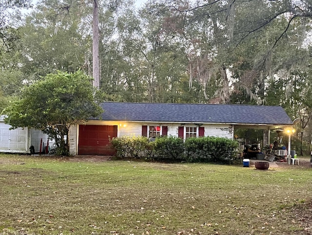 ranch-style home featuring a front yard and a garage