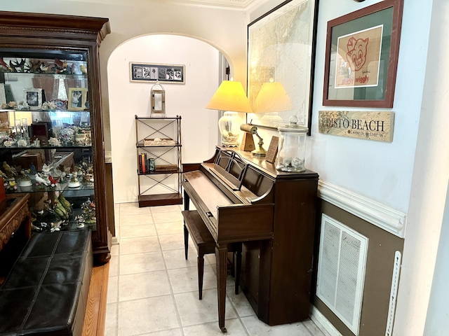 miscellaneous room featuring light tile patterned floors and crown molding