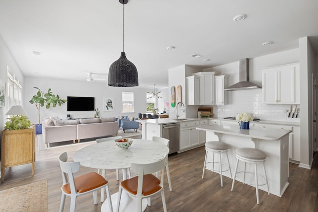 1825 Crossbill Trl, Hanahan, SC 29410 - kitchen with wall chimney exhaust hood, appliances with stainless steel finishes, white cabinets, light countertops, and recessed lighting