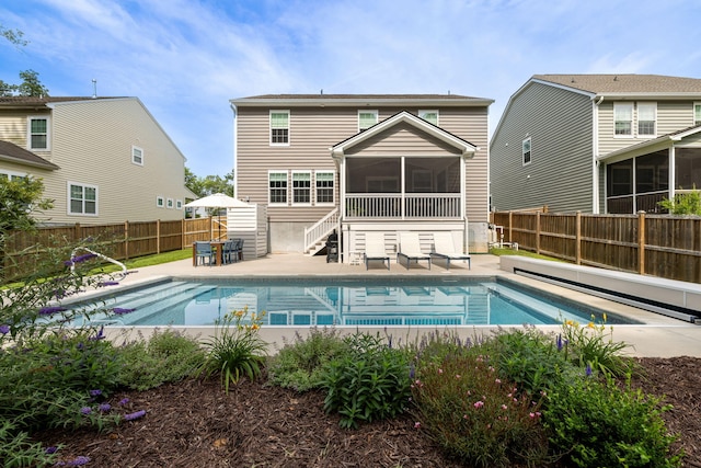 1825 Crossbill Trl, Hanahan, SC 29410 - back of property with a sunroom, a fenced backyard, stairway, and a patio