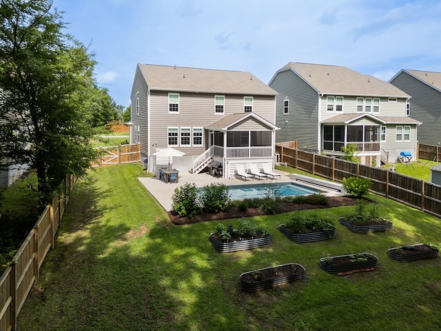 1825 Crossbill Trl, Hanahan, SC 29410 - back of house featuring a sunroom, a vegetable garden, and a patio