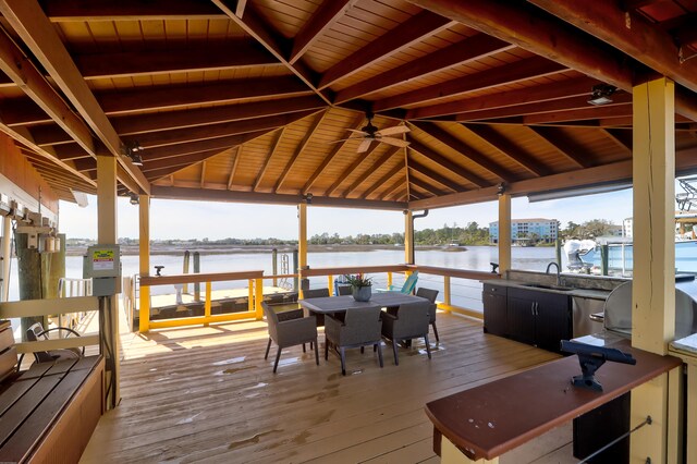 wooden deck featuring a gazebo, a water view, ceiling fan, and sink