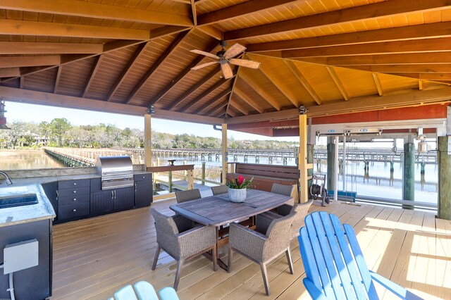 wooden deck featuring ceiling fan, area for grilling, a gazebo, and exterior kitchen