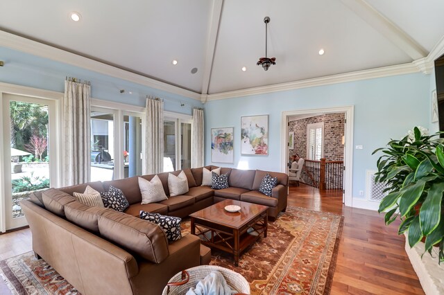 living room with vaulted ceiling with beams and hardwood / wood-style floors