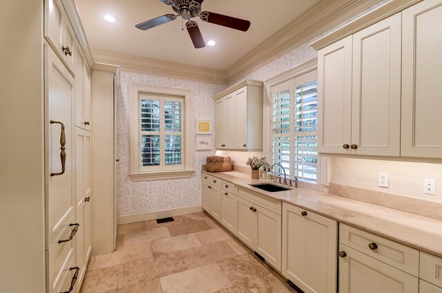 kitchen with crown molding, ceiling fan, sink, light tile floors, and tasteful backsplash