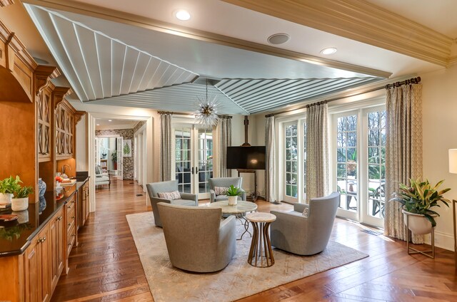 living room with french doors, crown molding, and hardwood / wood-style floors