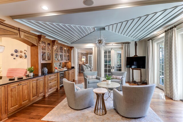 living room featuring french doors, beverage cooler, and hardwood / wood-style floors